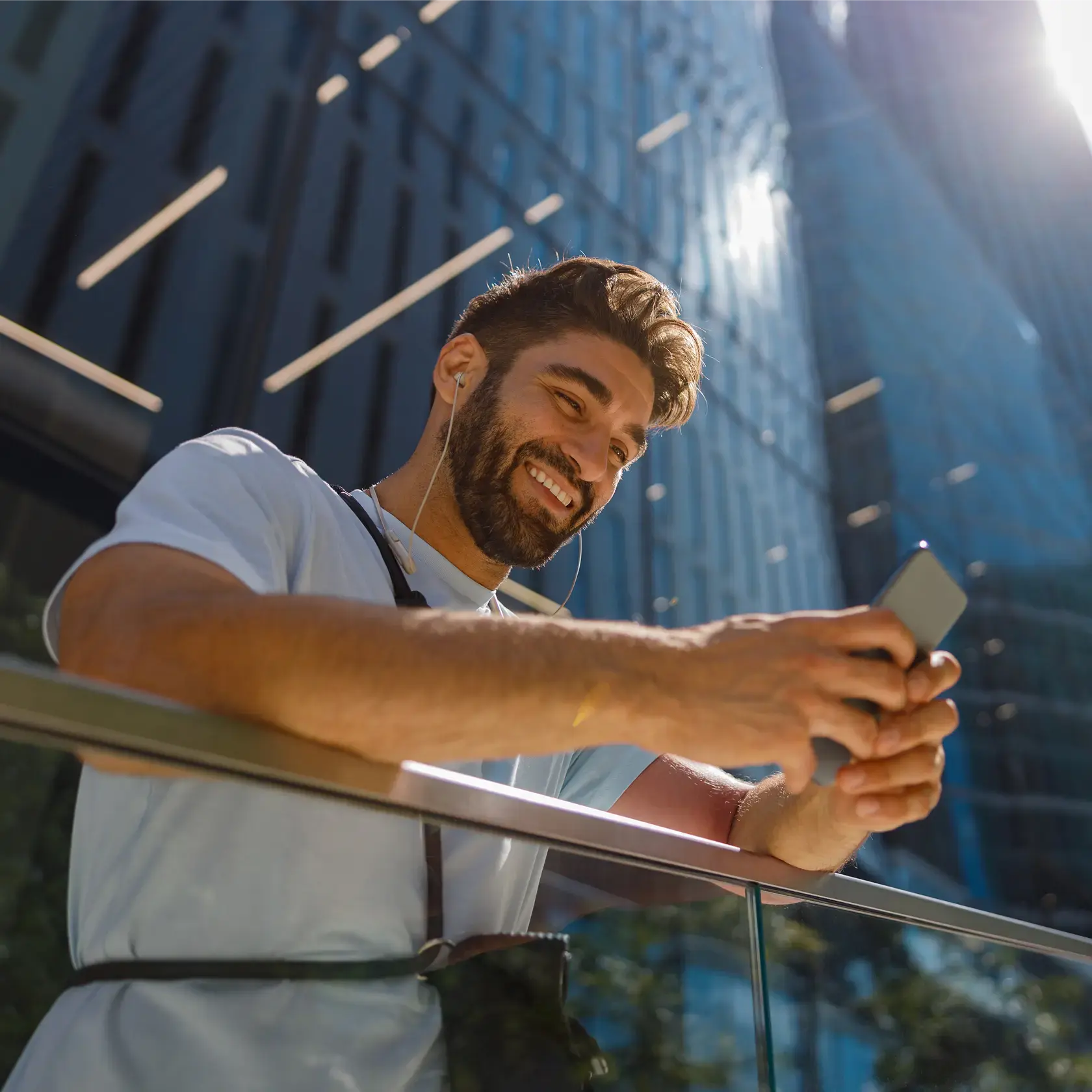 Man using smartphone for gold trading with Deriv in urban setting